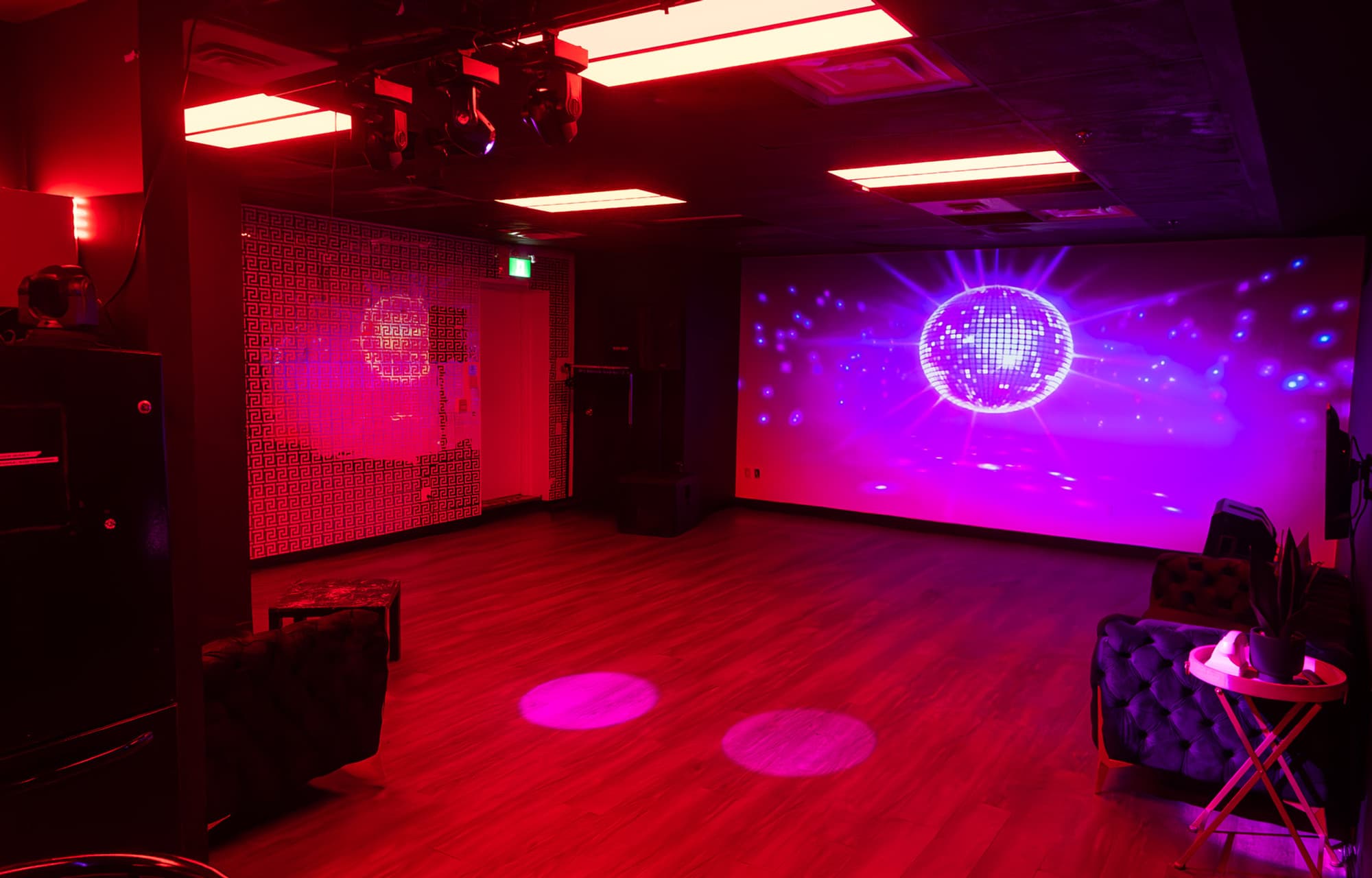 Lush Event Space event room — gold Versace wall, projected disco ball, dance floor