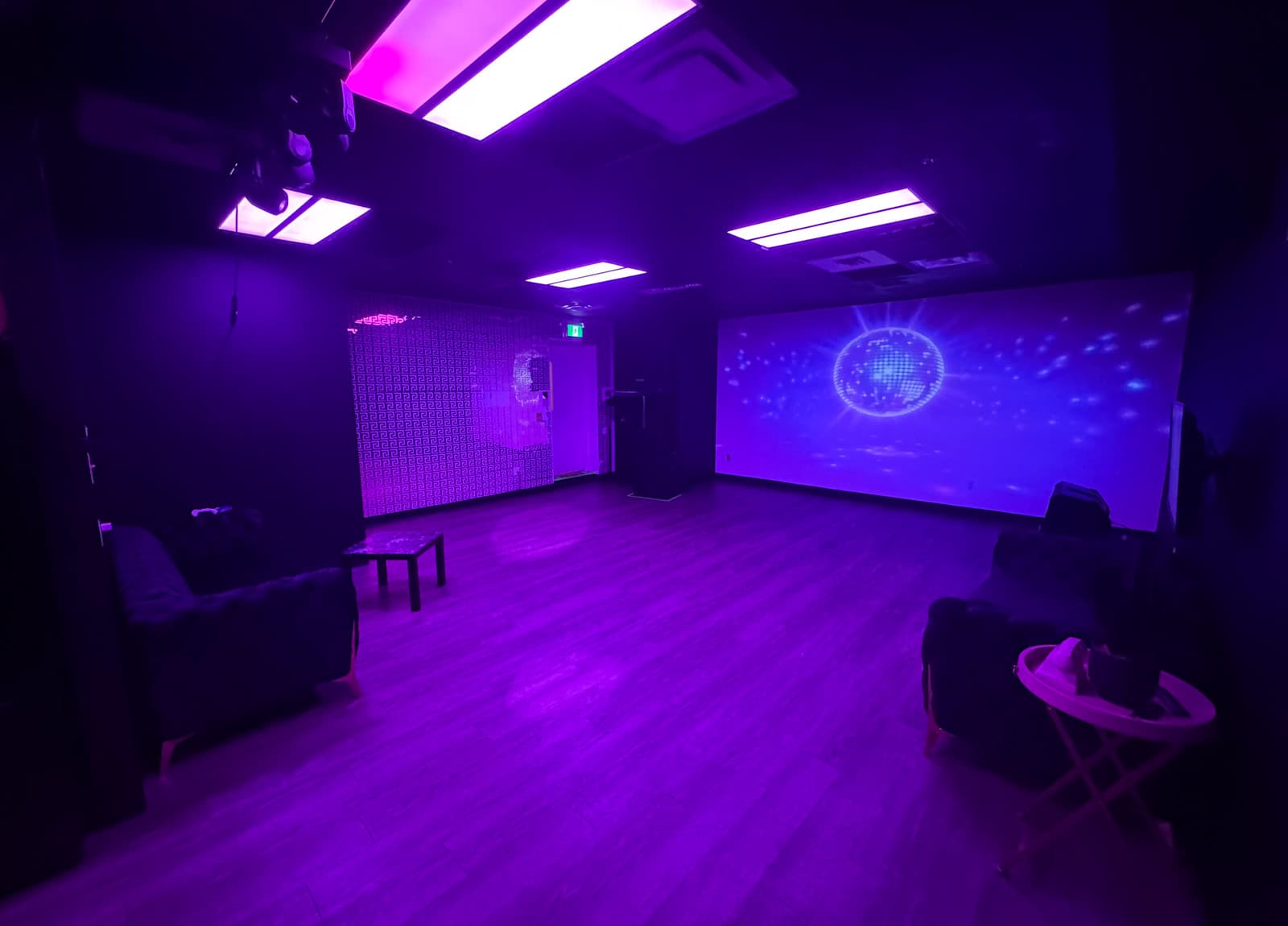 Lush Event Space room in purple ambient light with disco ball projection